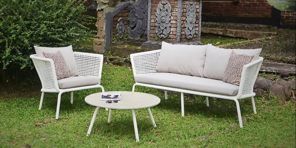 Garden sofa and armchair with round coffee table with stone top in garden in benahavis