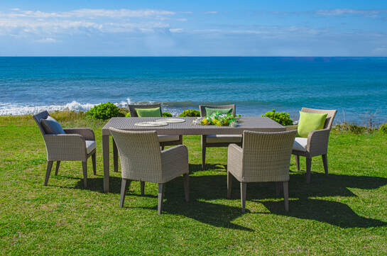 Outdoor table and chairs made with synthethic polyrattan in a landscape in Sotogrande sea coast