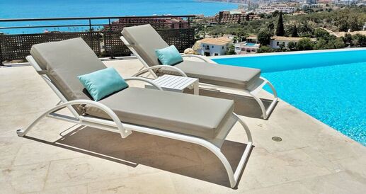 waterproof sunolounger cushions near a swimming pool in Estepona