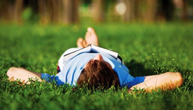 man lying on grass in a sunny day in la costa del sol