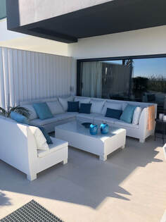Outdoor corner sofas and armchairs un a pentohuse placed in Marbella Los Monteros near the Hospital