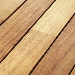 Slats of wooden outdoor table with teak oil applied