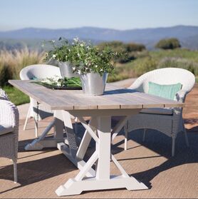 wooden teak table and rattan chairs in casares with outdoor rug