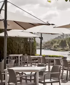 sinthethic chairs and tables and umbrellas in sotogrande restaurant